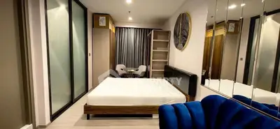 Modern bedroom with stylish decor and spacious layout, featuring a cozy bed and elegant furnishings.