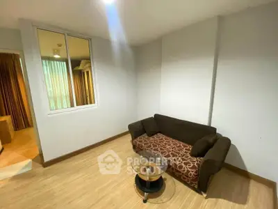 Cozy living room with modern sofa and glass coffee table in a stylish apartment.