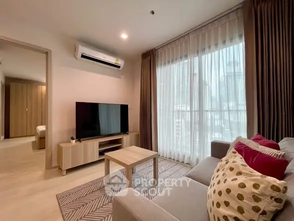 Modern living room with large window and stylish decor in urban apartment