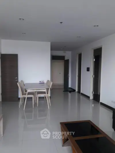 Spacious modern living room with sleek furniture and minimalist design, perfect for contemporary living.