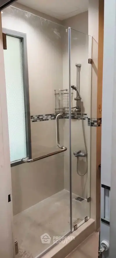 Modern bathroom with glass shower enclosure and sleek fixtures