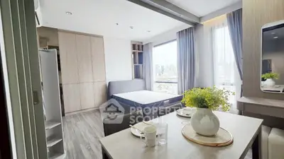 Modern studio apartment with city view, stylish decor, and natural light.