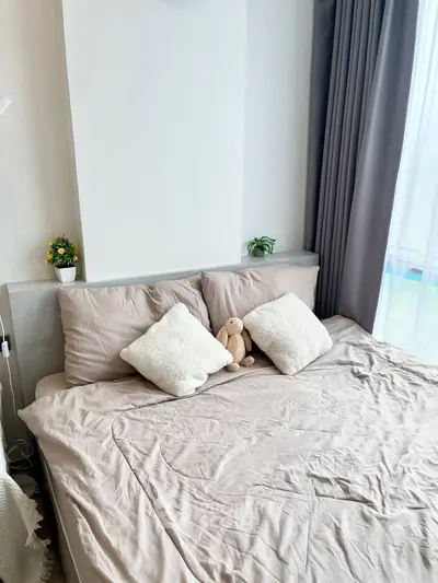 Cozy bedroom with plush bedding and soft lighting, perfect for relaxation.