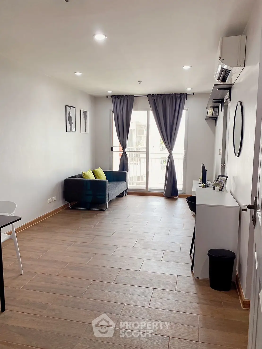 Spacious living room with modern decor and large windows for natural light.