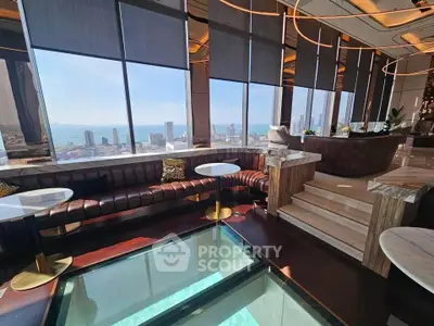 Luxurious penthouse with stunning city and ocean views, featuring elegant seating and modern design.