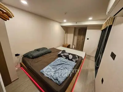 Modern minimalist bedroom with platform bed and ambient lighting