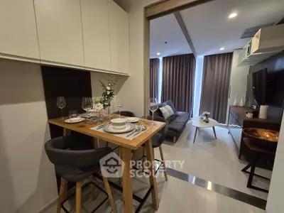 Modern living room with dining area and stylish decor in open layout apartment.
