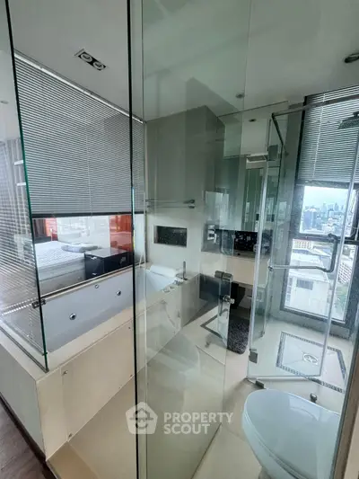 Luxurious bathroom with glass walls and city view, featuring a modern bathtub and sleek design.