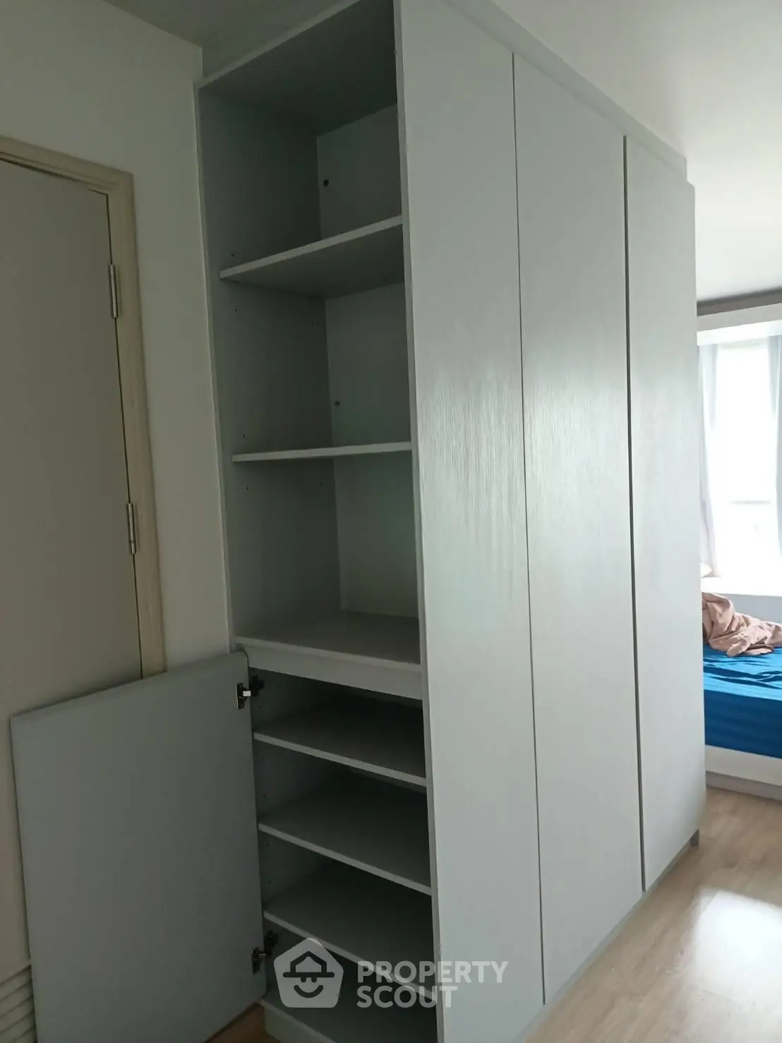 Spacious built-in wardrobe with open shelving in modern bedroom