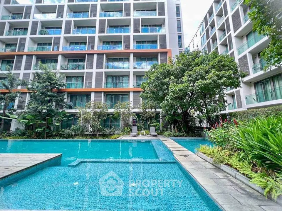 Luxurious condominium with stunning pool and lush garden view