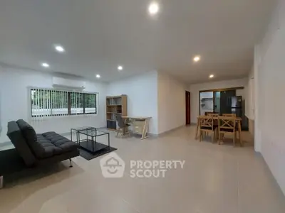 Spacious modern living room with dining area and sleek furniture