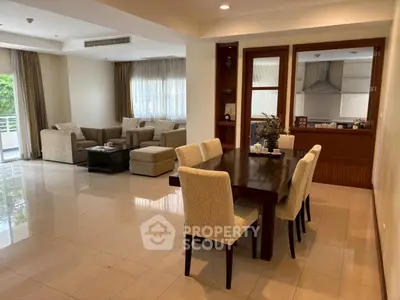 Spacious open-plan living and dining area with elegant furnishings and natural light.