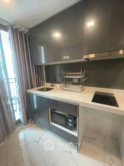 Modern kitchen with sleek cabinetry and balcony view