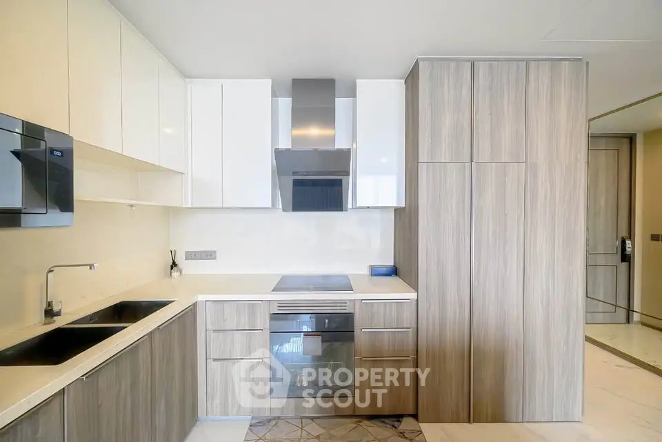 Modern kitchen with sleek cabinetry and built-in appliances in a stylish apartment.