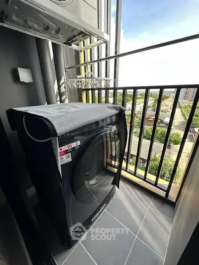 Modern balcony with washing machine and city view, perfect for urban living convenience.