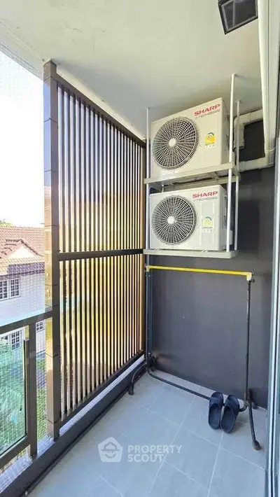 Modern balcony with air conditioning units and sleek railing design