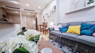Cozy living room with modern decor and comfortable seating in a stylish apartment.