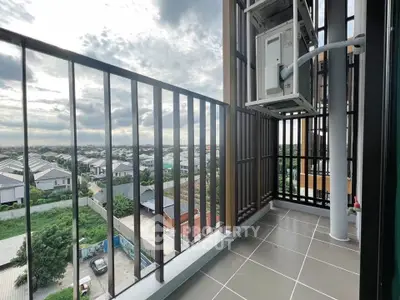 Spacious balcony with stunning cityscape view, perfect for relaxation and enjoying the outdoors.