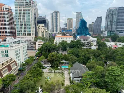 Stunning cityscape view with lush greenery and modern skyscrapers, perfect for urban living enthusiasts.