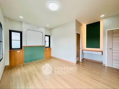 Spacious modern living room with wooden flooring and stylish accent wall