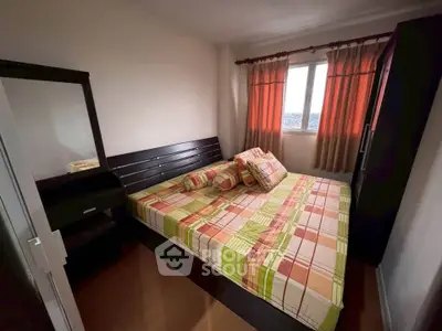 Cozy bedroom with large window and stylish decor, perfect for relaxation and comfort.