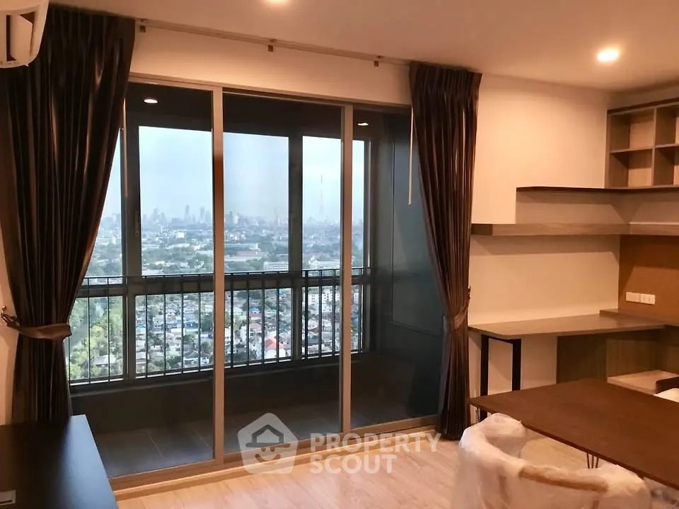 Modern living room with city view from large balcony, featuring stylish furniture and elegant decor.