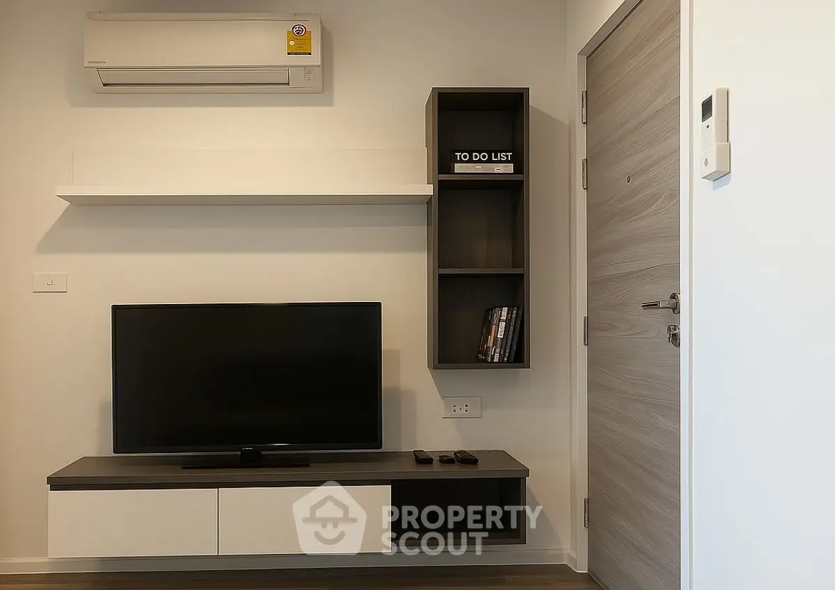 Modern living room with sleek TV setup and air conditioning unit