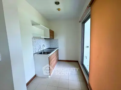 Compact kitchen with modern design and large window for natural light