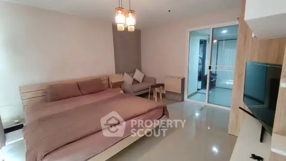 Spacious modern bedroom with cozy seating area and sleek design