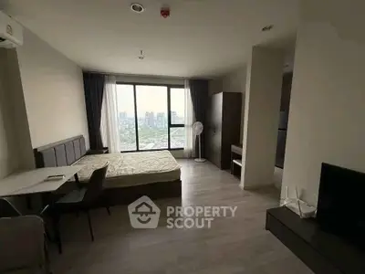 Spacious modern bedroom with city view, featuring sleek furniture and large windows for natural light.
