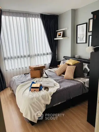 Cozy bedroom with stylish decor and large window for natural light