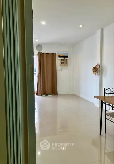 Spacious and bright living room with modern decor and large windows.