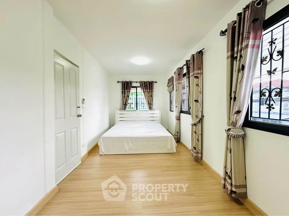 Spacious bedroom with natural light and elegant decor in modern home