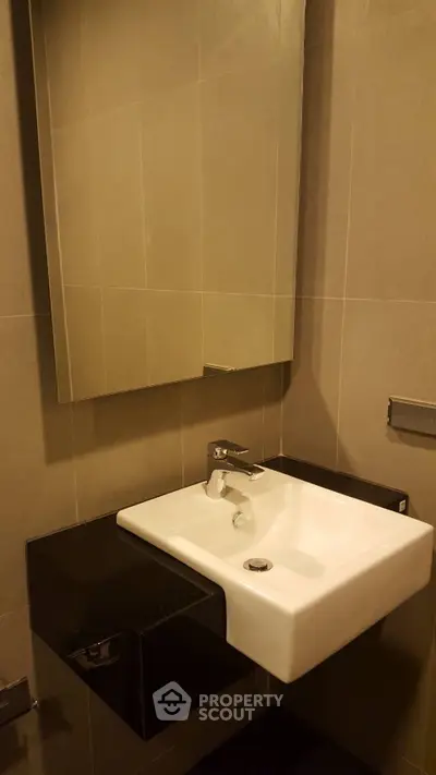 Modern bathroom with sleek sink and mirror in elegant design