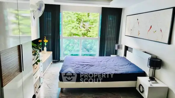 Modern bedroom with large window and stylish decor