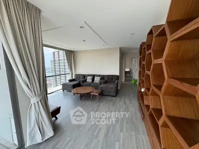 Spacious modern living room with large windows and stylish wooden shelving