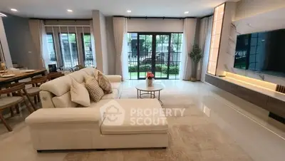 Luxurious living room with modern decor and garden view, perfect for relaxation and entertainment.