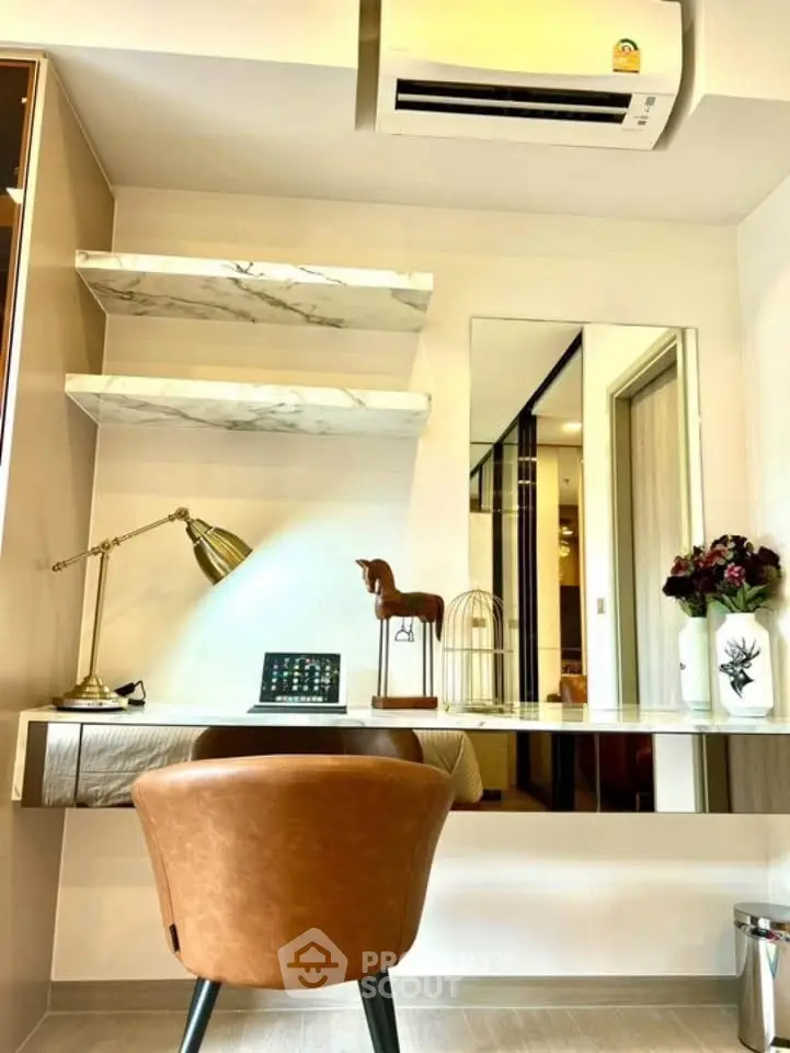 Modern study room with elegant desk, stylish chair, and decorative shelves in a contemporary apartment.