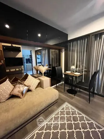 Modern living room with elegant decor and open layout, featuring stylish furniture and floor-to-ceiling windows.