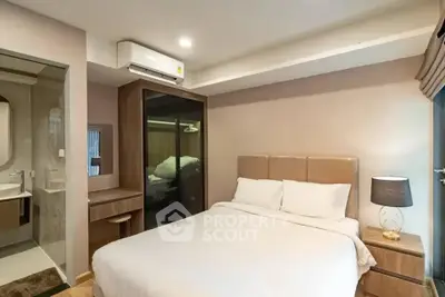 Modern bedroom with ensuite bathroom and stylish decor in a cozy apartment.