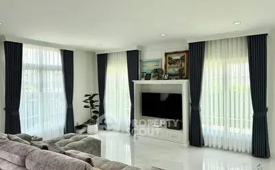 Spacious living room with elegant decor and large windows for natural light.