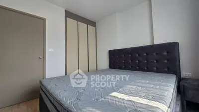 Modern bedroom with stylish bed and built-in wardrobe in a cozy apartment.