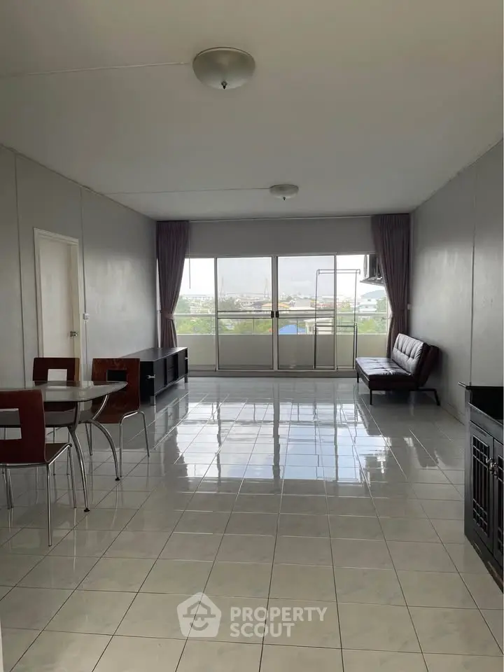 Spacious living room with large windows and modern furniture