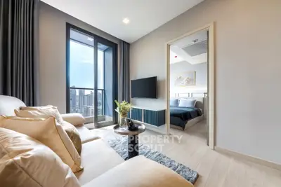 Modern living room with city view and cozy bedroom access