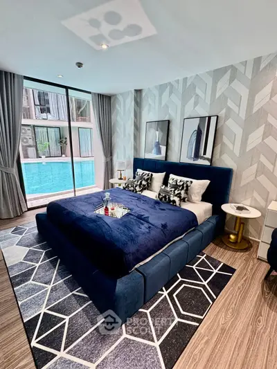 Luxurious bedroom with pool view, modern decor, and elegant furnishings for ultimate comfort.