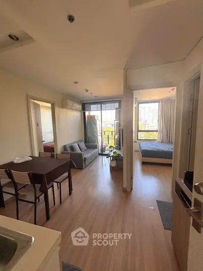 Modern apartment interior with open living area and balcony view