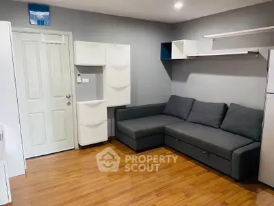 Modern living room with sleek gray sofa and stylish storage solutions.