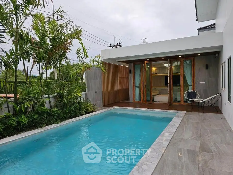 Luxurious modern villa with private pool and lush garden, perfect for relaxation and entertaining.