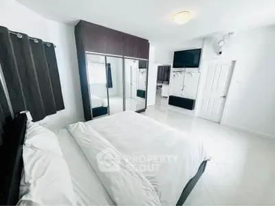 Spacious bedroom with modern wardrobe and cozy bed in bright apartment.