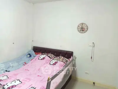 Cozy bedroom with unique cartoon-themed bedding and minimalist decor